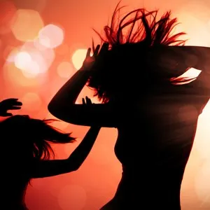 dancing silhouettes of woman in a nightclub