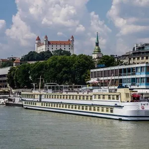 cruise ship on the Danube with the Bratislava Castle in the background