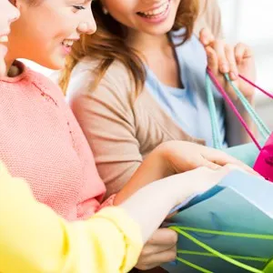 people, sale, consumerism and lifestyle concept - close up of happy teenage girls or young women with shopping bags