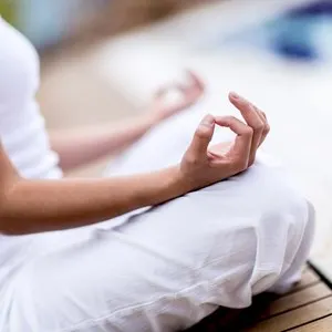 Yoga woman meditating and making a zen symbol with her hand