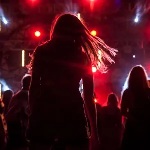 Dancing people at night concert party, blury background