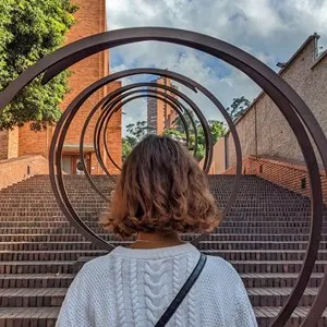 woman inside a modern art installation outside MAMBO