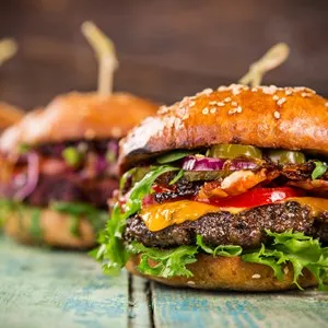 Close-up of home made tasty burgers on wooden table