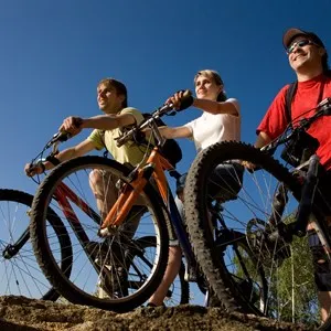 Three bicycles on the brink of a rock and look afar.