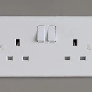 Standard generic double British plug socket for a three pin plug. Domestic home electrical installation or equipment power point