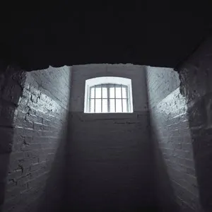 black and white prison cell with window