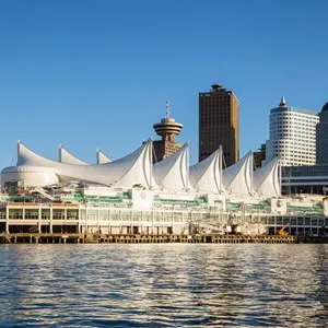 Canada Place and commercial buildings in Downtown Vancouver Viewed from water during sunset.