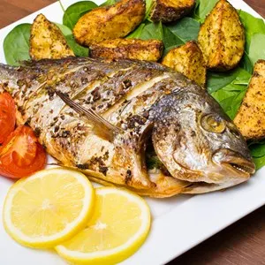 Roasted gilthead fish with baked potatoes