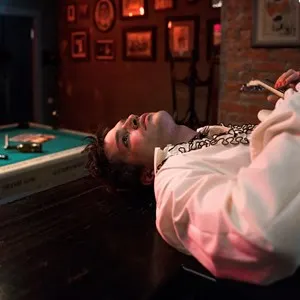 Man with punk make-up Lying on a Bar Counter