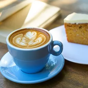 cappuccino with cake and book