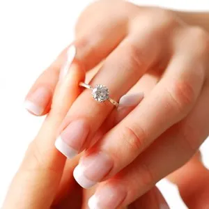 Woman tries on her diamond engagement ring