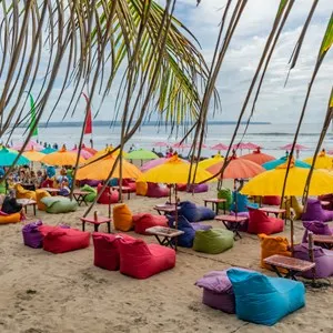 Bali, Indonesia. Tourists enjoy the sunset over the famous Seminyak beach in south Bali.