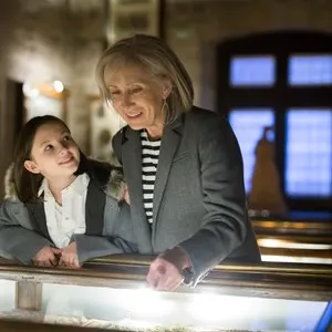 Friendly female tutor helping preteen girl