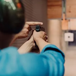 The trainer explaining to the man how to use the gun. Training in the shooting range