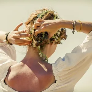 girl on beach with leather medal bracelets