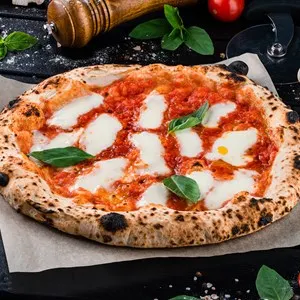 Neapolitan pizza with spices, tomatoes and cheese