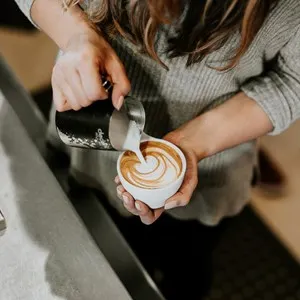 barista pouring a cappuccino