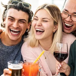 Multiracial friends celebrating party drinking cocktails at bar restaurant