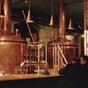 two man sitting in front of brewing equipment at Birrificio Torino
