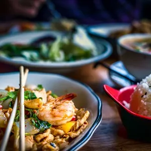 Colorful Thai food in a restaurant settings; various dishes on the table; colorful food, Asian food