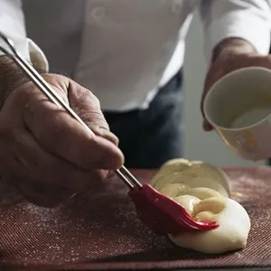 Baker kneading dough in a bakery. Bakery Concept.