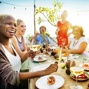 happy family having a dinner at sunset