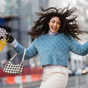 woman with shopping bags looking very happy