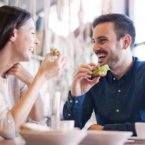 Couple eating sandwiches at a sandwich shop - San Francisco, California