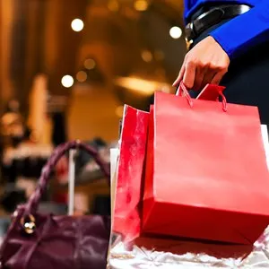 woman in a shopping mall with colorful bags