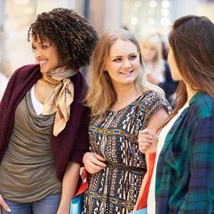 Three Female Friends Shopping In a Mall Together