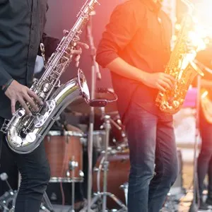 World Jazz festival. Saxophone, music instrument played by saxophonist player and band musicians on stage in festival