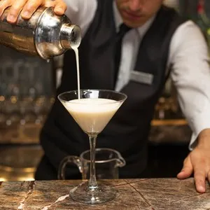 Barman pouring drink