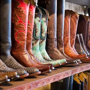 Cowboys boots on a shelf in a store, aligned