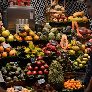 man talking to a tropical fruit vendor
