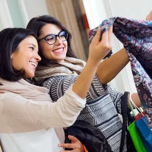 Portrait of two girls shopping in a clothes shop.