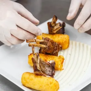 Roasted lamb chops garnished with mashed potato-filled croquettes