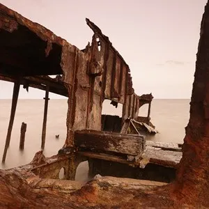 Rusted away ship wrecks in the sand