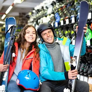 Happy customers are demonstrating their choice of boots for skiing in sport shop