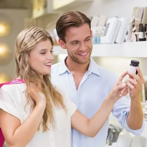 A couple testing a sample of beauty products in the mall