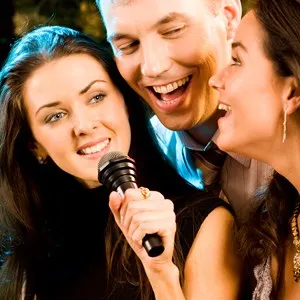 Three friends singing karaoke together