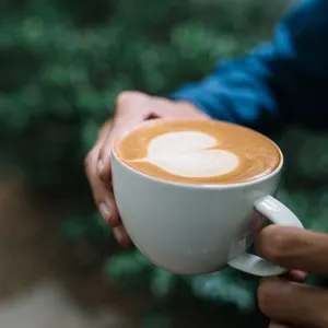 Holding a cup of latte.