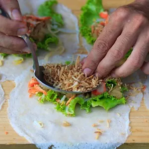 Man making spring rolls at the market