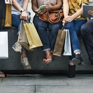 group of people chilling with shopping bags