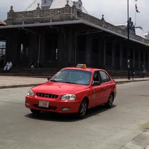 red taxi in front of the train station in San Jose