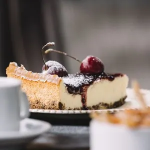 Cheescake with coffee on the table outdoors