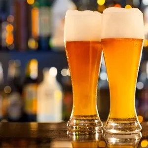 Jugs of beer placed on bar counter with free space for text