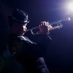 Musician playing the Trumpet with spot light and len flare on the stage