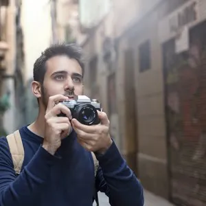 Young man taking photos in Barcelona