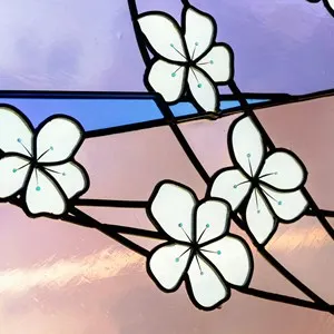 a close-up o a stained glass window with flowers