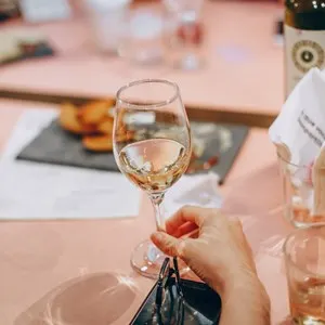 a glass ow white wine at a restaurant